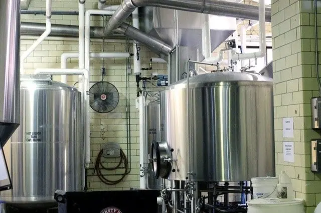 Stainless steel brewing tanks and pipework in a food processing facility