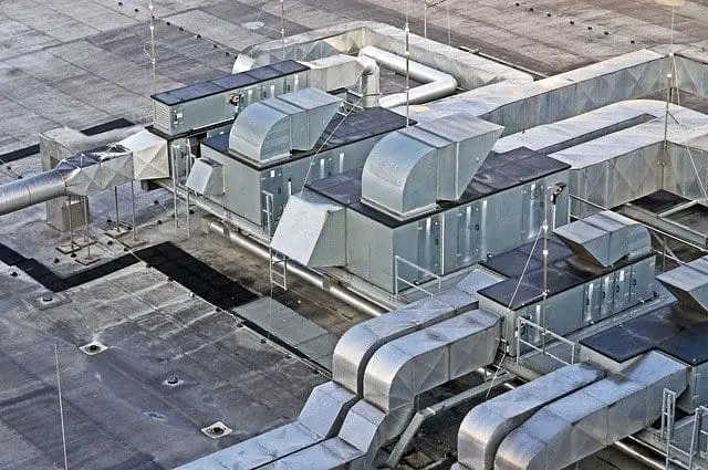 Industrial rooftop ventilation units connected by extensive galvanised ducting